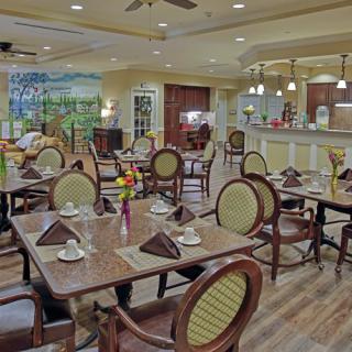 A cozy restaurant dining area with elegantly set tables, inviting decor, and warm lighting.