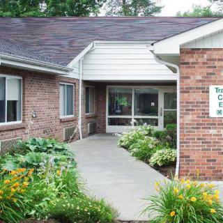 Entrance to a brick building with landscaped walkway.