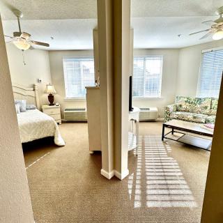 A cozy apartment with a combined bedroom and living area featuring modern furnishings.