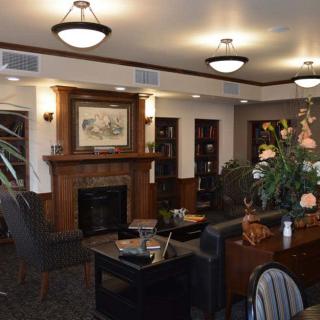 A cozy lounge area with comfortable seating, a fireplace, and elegant lighting.