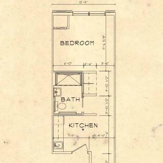 A detailed floor plan showcasing the layout of a compact apartment with a bedroom, bathroom, and kitchen.