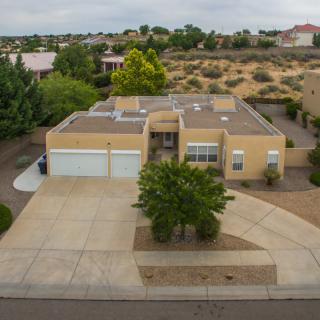Aerial view of a suburban house with desert landscaping and a spacious driveway.
