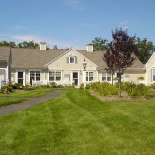 A suburban house with a well-maintained lawn and landscaping.