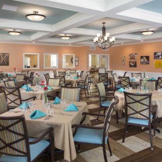 An elegant dining room with tables neatly set for guests.