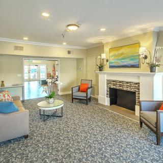 A cozy living room with comfortable seating and a decorative fireplace.