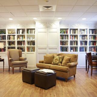 Cozy library with comfortable seating and well-stocked bookshelves.
