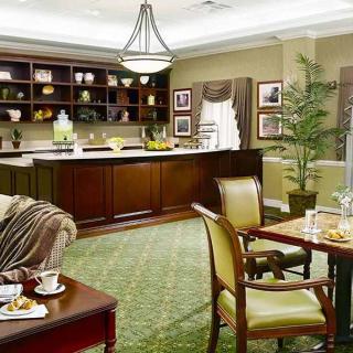 A modern living space featuring a kitchen, dining area, and elegant furniture.