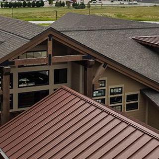 Modern building with a combination of metal and shingle roofing.