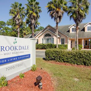 A senior living community with a welcoming entrance and well-maintained landscaping.