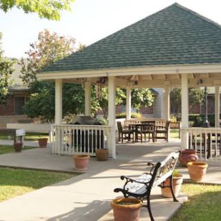 A serene outdoor gazebo surrounded by lush greenery, perfect for relaxation and gatherings.