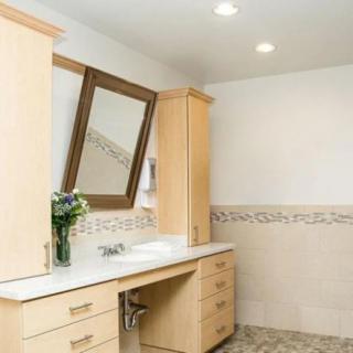 Modern bathroom interior with a wooden cabinet, large mirror, and decorative tiles.