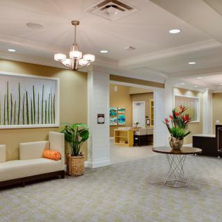 A modern lobby with elegant seating, artwork, and decorative plants.