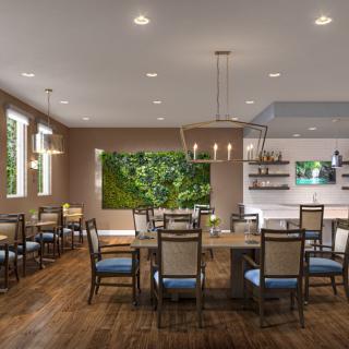 A modern dining room with elegant furnishings and decor, including wood flooring and contemporary lighting.