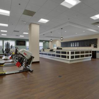 A modern gym interior with spinning bikes and bright lighting.