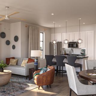 A modern open-concept living room and kitchen area with stylish furniture and decor.