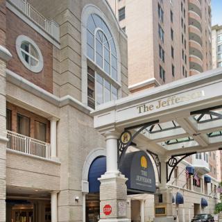 The entrance to a high-rise hotel building in an urban setting.