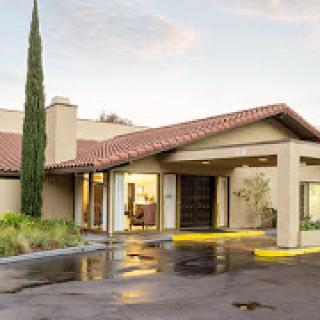 A modern residential building entrance with a welcoming driveway.