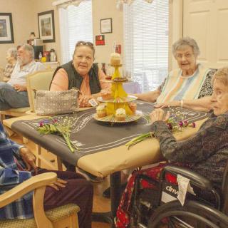 A group of elderly individuals enjoying a social gathering indoors.