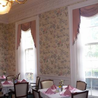 An elegant dining room with classic decor and neatly set tables.