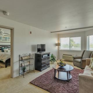 A cozy living room with a television and comfortable seating.