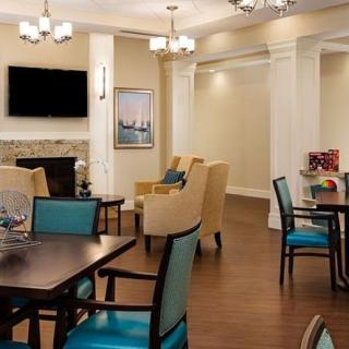 A cozy living room with a fireplace, television, and comfortable seating.