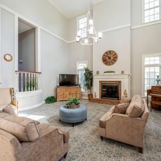 A spacious living room with comfortable seating and elegant decor.