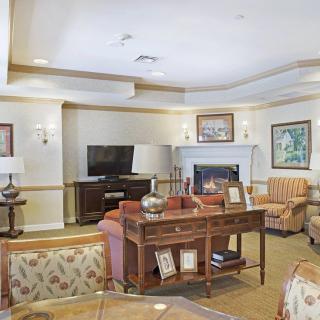 A cozy living room with comfortable seating, a television, and a fireplace.