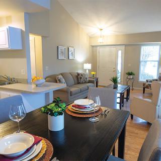 A modern open-concept living and dining area in an apartment.