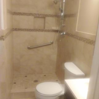 Compact bathroom with a shower and toilet.