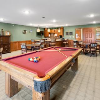 A cozy recreation room featuring a pool table, perfect for leisure and entertainment.