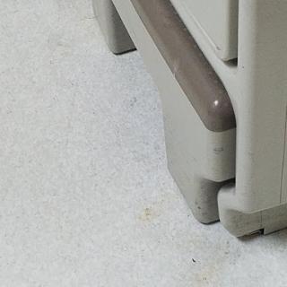 A close-up view of the corner and base of a storage cabinet.