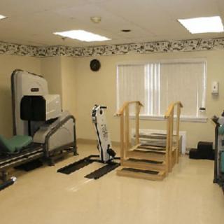 A physical therapy clinic with various rehabilitation equipment.