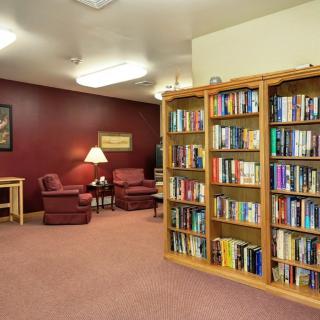 A cozy library area with bookshelves and comfortable seating.