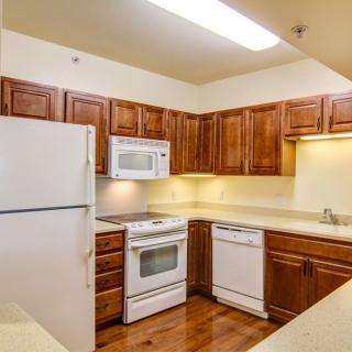 A cozy kitchen with wooden cabinets and modern appliances.