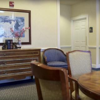 A well-appointed waiting room with comfortable chairs and a decorative table.