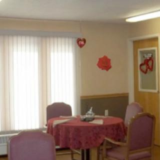 A small dining area with Valentine-themed decorations and a table set for four.