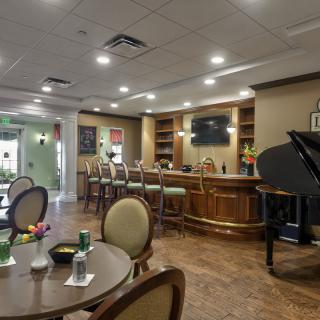 A cozy lounge bar with elegant seating and a grand piano.