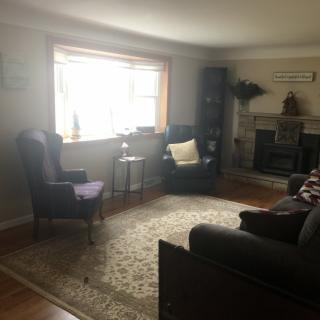 A cozy living room with comfortable seating and a fireplace.
