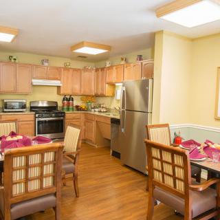 A cozy kitchen and dining area with modern appliances and wooden furniture.