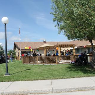 A lively restaurant scene with outdoor seating and people enjoying the day.