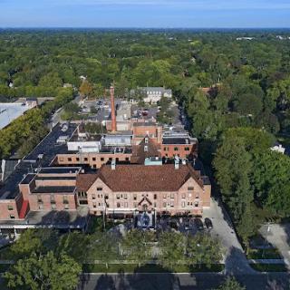 An aerial view showcasing a mix of historic buildings surrounded by lush greenery.