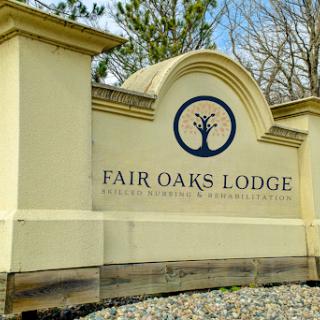 Signage of Fair Oaks Lodge, welcoming guests to a serene outdoor retreat.