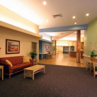 A well-lit lobby with comfortable seating and pleasant decor.