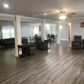 Spacious modern living area with comfortable seating and wood flooring.