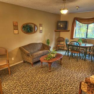 A cozy living room featuring a couch, dining area, and decorative elements.