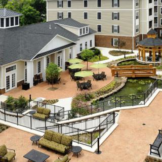 A well-maintained residential courtyard with outdoor seating and landscaped gardens.
