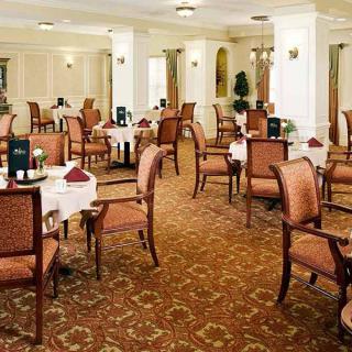 An elegant dining room with neatly arranged tables and chairs.