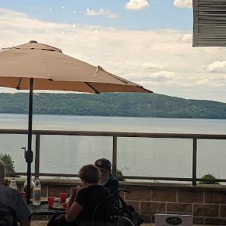 A relaxing outdoor dining experience by the water with scenic views.