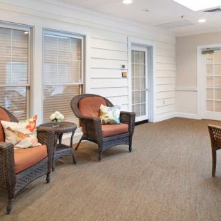 A cozy waiting room with wicker chairs and soft lighting.