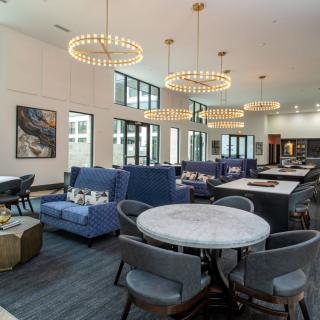 A modern lounge area with stylish seating and elegant chandeliers.